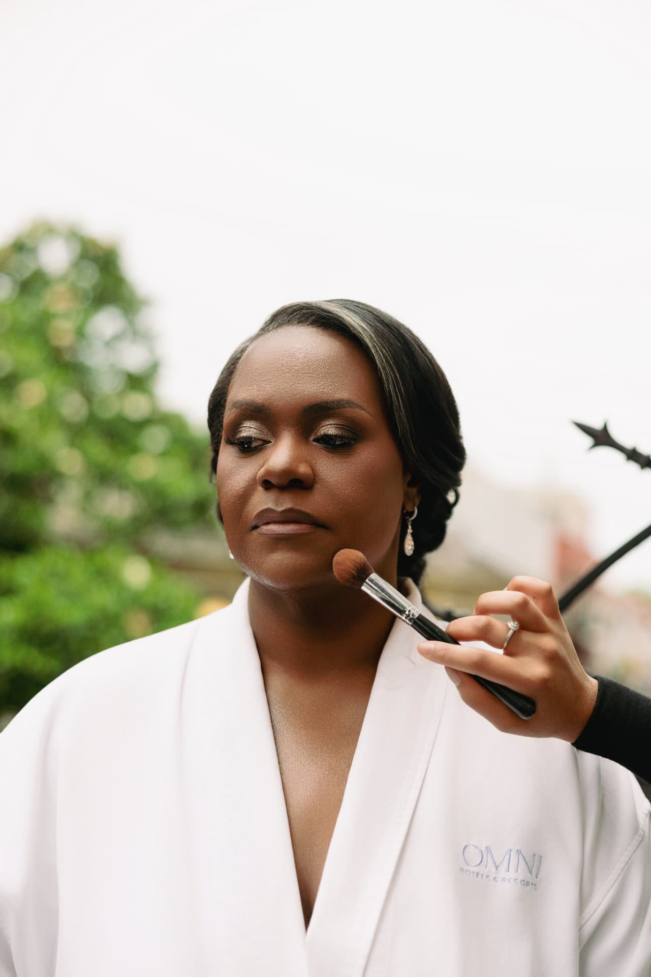 Bride having her finishing makeup touches applied